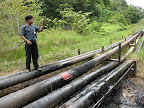 An indigenous monitor visits a spill caused by a pipeline rupture in Oil Block 1-AB near the community of Antioquia