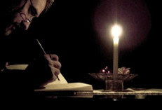 c0 man writing by candlelight