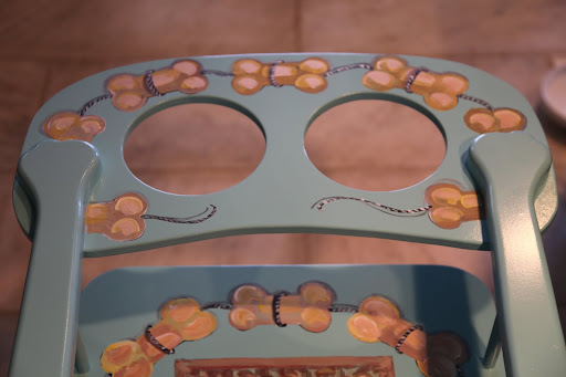 There are holes cut out to recess a water and food bowl.