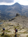 Descending the granite slabs towards the Etang Soula Couloume with the Pic Pedros (2842m) in the background.