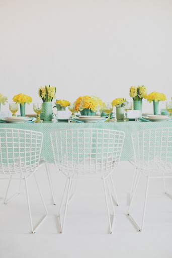 Combining high and low vases with groupings of flowers packs a visual punch.