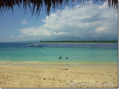 The kids swimming on the beach, view from our bamboo sala