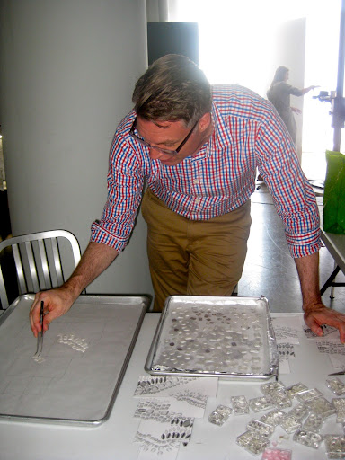 Design director, Michael McCormick, begins to map out the design of the necklace before it is applied to the cake.