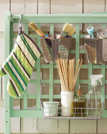 The lattice back of the grilling station offers plenty of space to organize all of your grilling utensils.