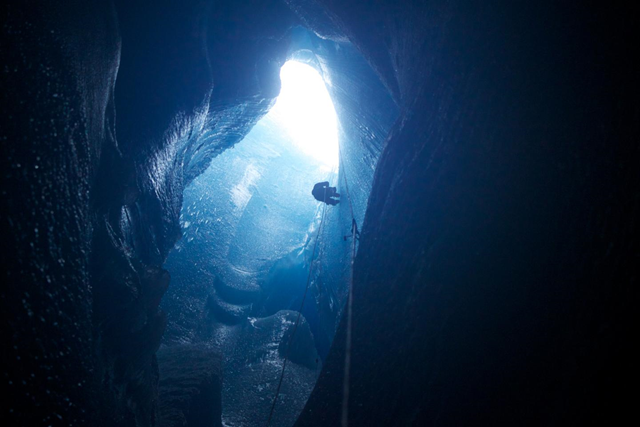 A scientist explores the remains of a supraglacial lake after it has drained. Related news release: Greenland Ice Sheet more vulnerable to climate change than previously thought. Photo: Sam Doyle