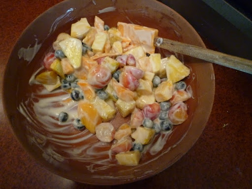 Steve whisks the dressing and salad together.