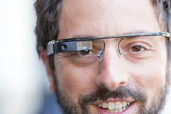 c0 A man sporting Google Glass over what appears to be conventional glasses. 