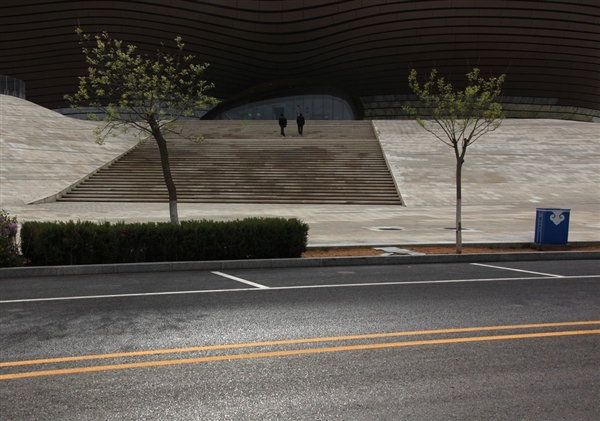 Two men walk down a deserted street in front of the unopened Ordos Museum on 11 May 2011. In the wake of a coal boom, Ordos was built to house up to 1 million people but only 30,000 live there today. David Gray / Reuters