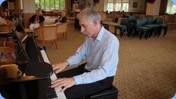 Claude Moffat playing the grand piano. Photo courtesy of Dennis Lyons.
