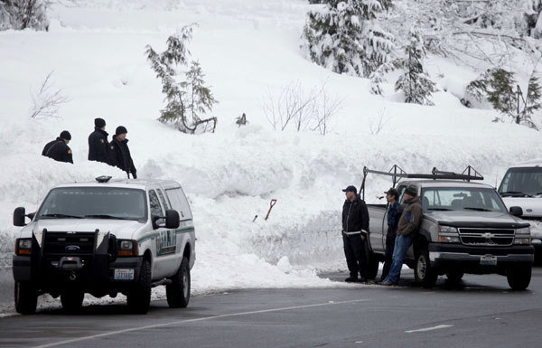 Emergency officials work near Stevens Pass ski resort in Skykomish, Washington, on 19 February 2012, after an avalanche killed three skiers. Erika Schultz / The Seattle Times