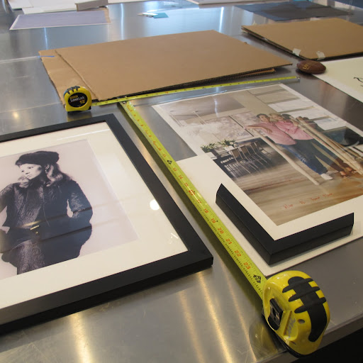 They measured the image and placed the mat and frame in position...