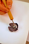 Next, she rolls out the petals using this metal tool.