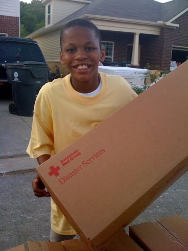 This young boy got busy and helped to pass out the Red Cross supplies.