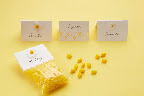 Place card, seating card, or favor bag decoration, these daisy stickers (included in sale) and punch (in the sale) can be used in many ways. The candy and bags are included in the sale.