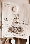 Ana's sketch shows the details she wants to include on each cake tier.