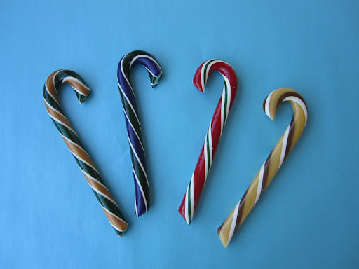 Non-traditional candy cane flavors, from left to right: Caramel Apple, Sugar Plum, Pomegranate, and Root Beer.