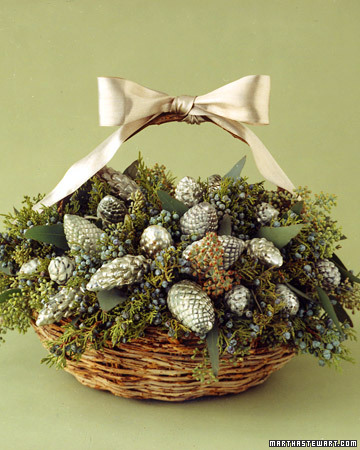 Vintage or new silver ornaments give a table luster. These pinecone-shaped examples are nestled in a basket, clustered among eucalyptus leaves and sprigs of cedar. Juniper enriches the frosty colors of the arrangement, as the blue-gray berries play off the silver ornaments.