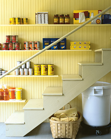 If the stairs leading to your cellar are wide enough, the wall beside them can be transformed into a pantry for items you use regularly, such as canned goods and other kitchen supplies.