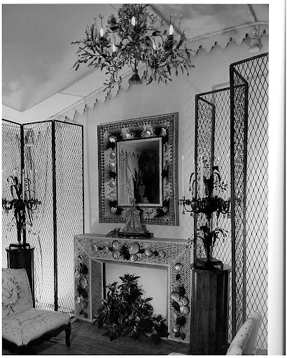 I love the tented ceiling of this room, as well as the wire screens, metal mesh fireplace, and mirror studded with rare seashells.
