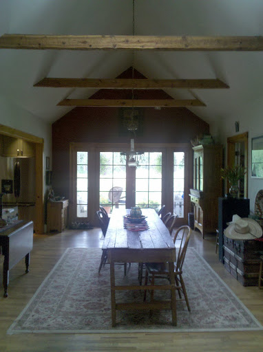 A look at the farmhouse's beautiful dining room, with a long wooden table perfect for entertaining.