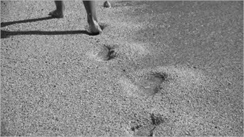 stock-footage-ultra-hd-k-view-child-walking-on-a-sandy-beach-coastline-sand-footprint-of-a-little-girl-waves