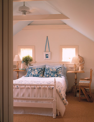 Placing matching nightstands and lamps on either side of a bed is a great way to lend balance to any bedroom. I particularly like the arrangement of this bed between the two small square windows. I think it emphasizes the room's light.