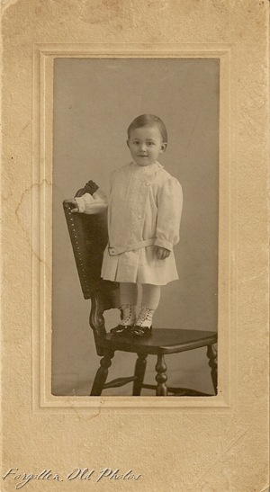 Child in Chair in cute shoes DL Antiques