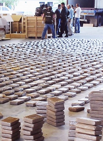 Colombian policemen check packages of cocaine after a 10.5 tons of cocaine seizure on October 25, 2008, in Barranquilla, Atlantico department, Colombia. According to authorities, the drug was seized in the Barranquilla seaport from where it was going to be sent to Veracruz, Mexico. AFP PHOTO/Jhony OLIVARES-EL HERALDO (Photo credit should read JHONY OLIVARES/AFP/Getty Images)