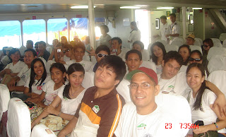 Students seated comfortably inside the ferry boat cabin.