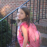 Abigal sports a pink outfit with her pink backpack for her first day of school.