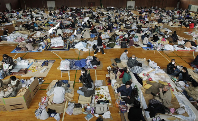 Evacuees, who fled from the vicinity of Fukushima nuclear power plant, rest at evacuation center in Kawamata, March 2011. Reuters