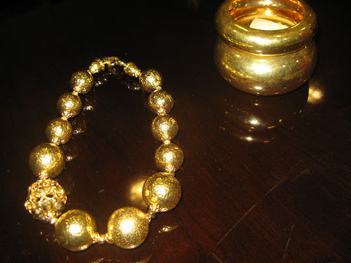 Necklace from Barrera and bracelets from Alexis Bittar.
