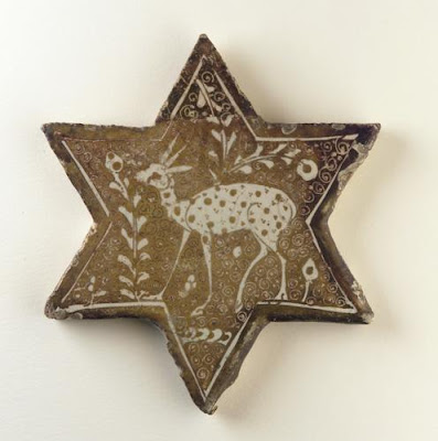 Tile | Origin:  Iran | Period: early 13th century  Saljuq period | Details:  Throughout the twelfth and thirteenth century, human and animal imagery permeated all media. Although the meaning and function of this sensitively rendered deer is unclear, it underlines the new artistic fascination with the natural world. | Type: Stone-paste painted over glaze with luster | Size: H: 14.3  W: 12.7  cm | Museum Code: F1903.197 | Photograph and description taken from Freer and the Sackler (Smithsonian) Museums.