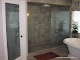 Etched glass in water closet door and shower enclosure.