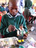 Philani really got into sculpting and here's a picture of him painting one of his sculptures in Art Club. South Africa - 462.jpg