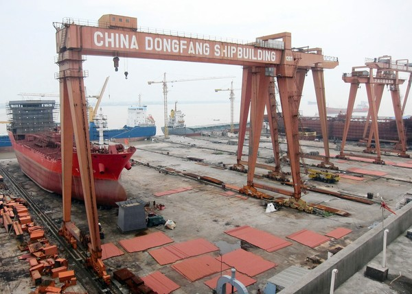 Amid China's economic woes, shipyards there have laid off thousands of workers and half-built vessels have been left to rust. Here, unfinished tankers sit idle at a ship builder, 9 July 2012. David Pierson / Los Angeles Times