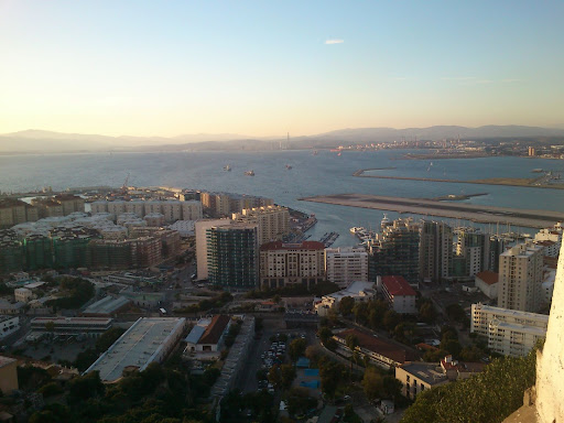 Trangt om saligheten. Flere postboksfirmaer enn innbyggere. Røyking i hotellbarer og lav skatt. Gibraltar er et fristed for gamblingselskaper og engelskmenn som holder fast i den siste koloni på det europeiske fastlandet. Gibraltars flystripe opp til høyre. Når flyene kommer fra England stenges veien inn til Gibraltar - som er over samme flystripe.