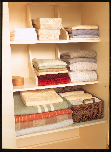 Shelf brackets mounted to the tops of shelves in clothes or linen closets make perfect dividers for keeping stacks straight.