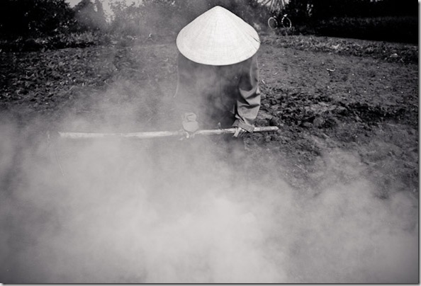 A farmer burns off crop residue to prepare for the upcoming harvest in Hanoi, Vietnam.
