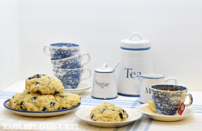 Host a High Tea Party. A melt in your mouth recipe for blueberry scones. Inspired by Starbucks in house version, this blueberry scone with hints of lemon and a crunchy sugary top will delight everyone. Serve during High Tea, or just as a mid afternoon snack. Perfect along side tea or coffee, or as a stand alone blueberry dessert. You won't believe how easy these are to make! Never made scones before? Never fear, this includes a step by step tutorial on how to make scones. #HighTea #blueberries #Starbucks #scones #dessert #DowntonAbbey Host a High Tea Party