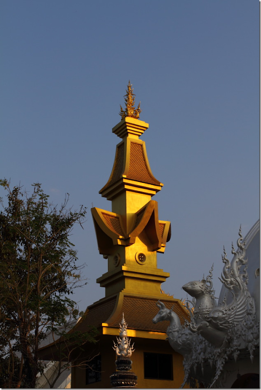 Golden tower next to White Temple, Chiang Rai