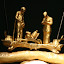 A close up of the figures on the top, examining the head.