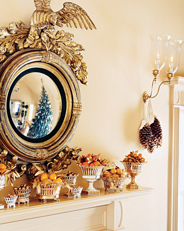 This gorgeous Federal mirror is hung above a mantel in Martha's summer house in Bedford that is lined with old Paris porcelain filled with citrus.(marthastewart.com)