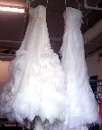 The best way to steam a wedding dress is to hang it from a high place. That way, the weighty skirt can flow free and help pull out any wrinkles.