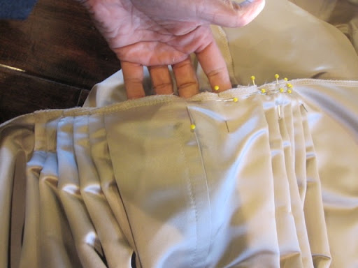 Originally, the skirt was going to be ivory, but they shifted plans to a mocha hue once the bodice was made. Two weeks out, Steven flew to NYC for a day to source additional fabric and then flew home to hand-pleat the skirt.