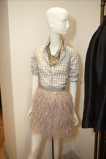 A great button down top with a fun and flirty feather skirt. And don't forget the accessories, check out the necklaces...we love them!