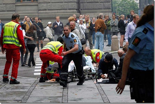 Injured people are treated by medics at the scene of an explosion near the government buildings in Norway's capital Oslo on July 22, 2011. At least one person was killed by the powerful explosion which ripped through government and media buildings. AFP PHOTO / SCANPIX / BERIT ROALD   -- NORWAY OUT -- (Photo credit should read ROALD, BERIT/AFP/Getty Images)