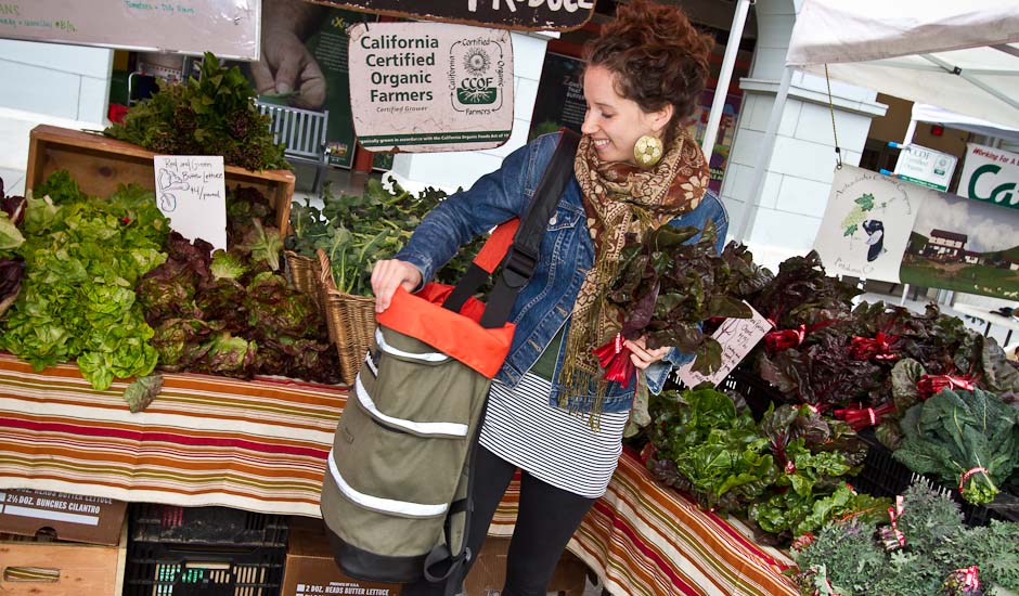 Victoria is using her farmer's market bag to tote her organic groceries home.