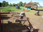 Fabricating steel trusses for roof structure over containers