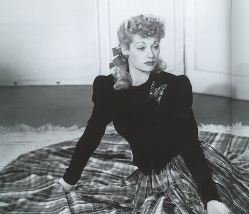We Love Lucy -- actress/comedienne Lucille Ball surrounded by a sea of tartan taffeta skirted dress with fitted black top, circa 1942. We Love Lucy -- actress/comedienne Lucille Ball surrounded by a sea of tartan taffeta skirted dress with fitted black top, circa 1942.